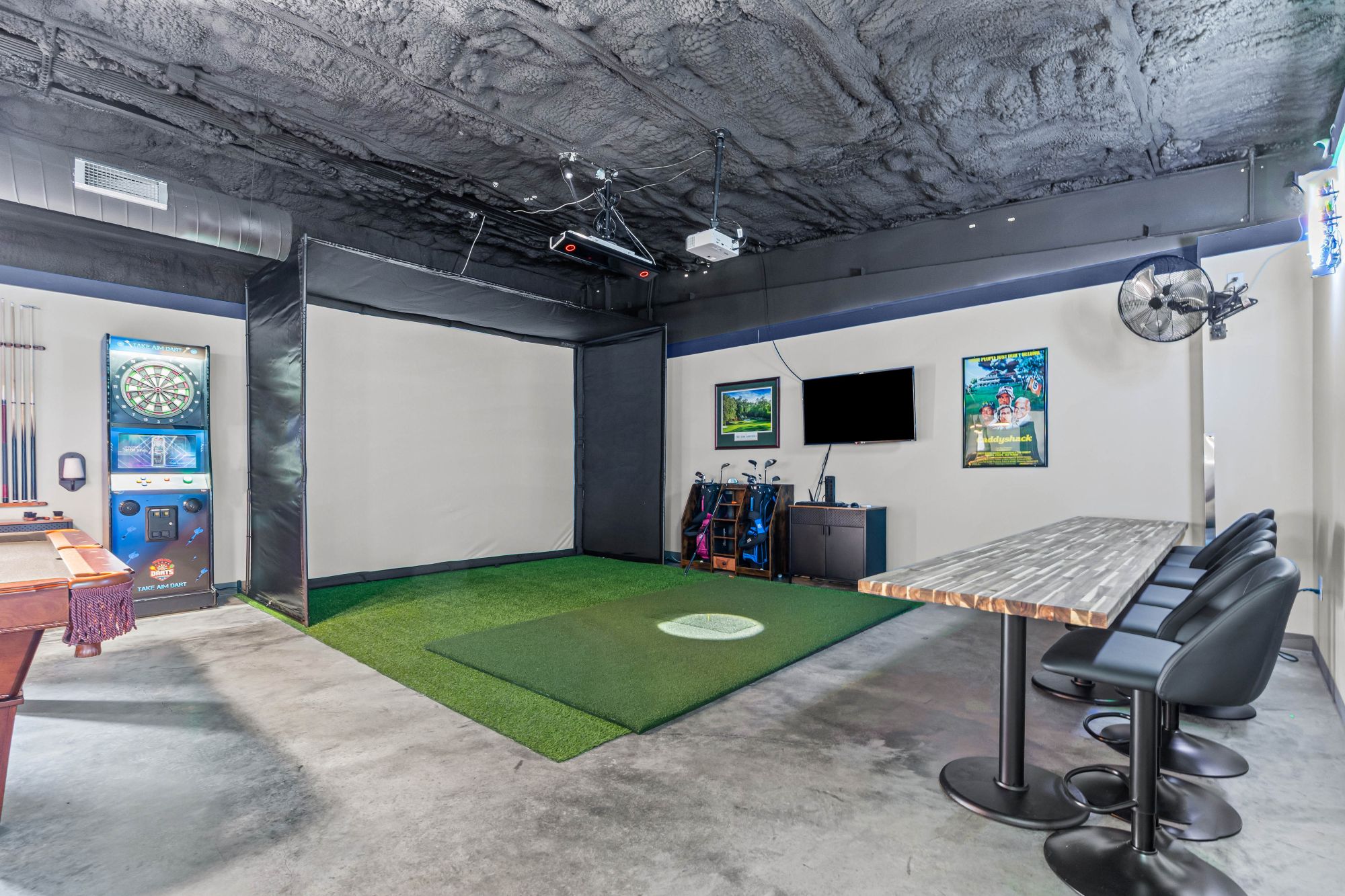 Indoor golf simulator room at Paradise Found RV Resort